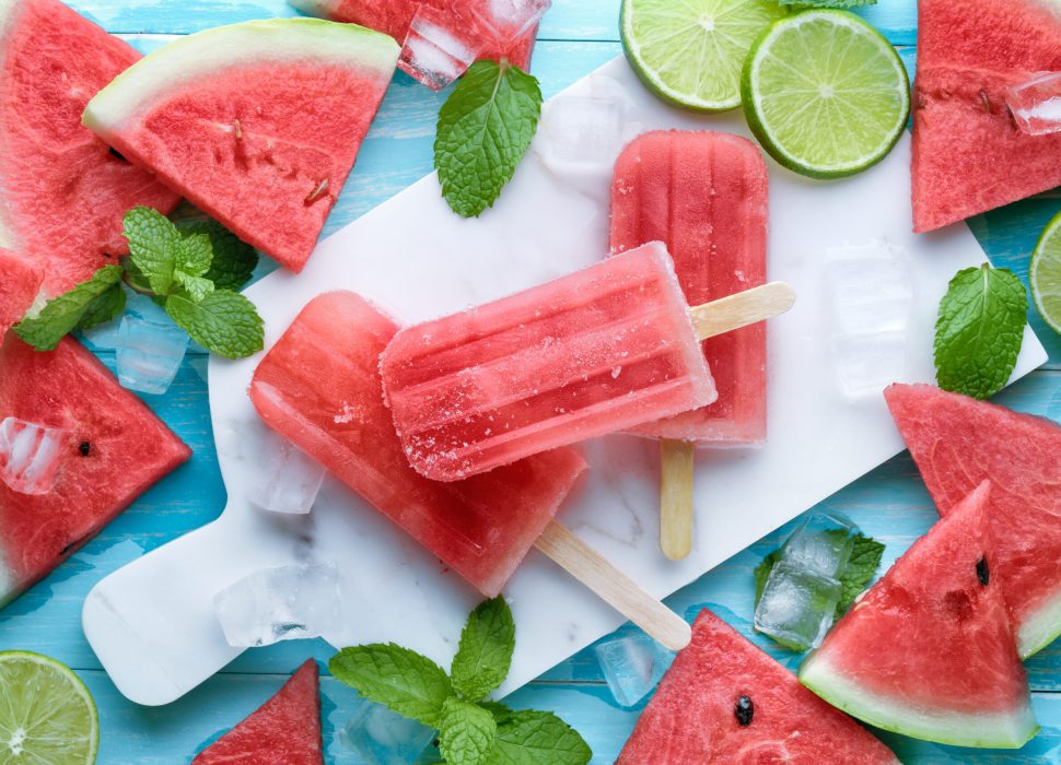 Watermelon,slices of lemon and mint leaves on blue background